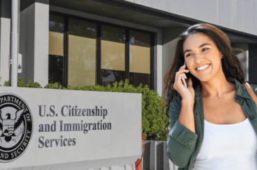 woman talking on phone and USCIS building - How to speak to a USCIS operator