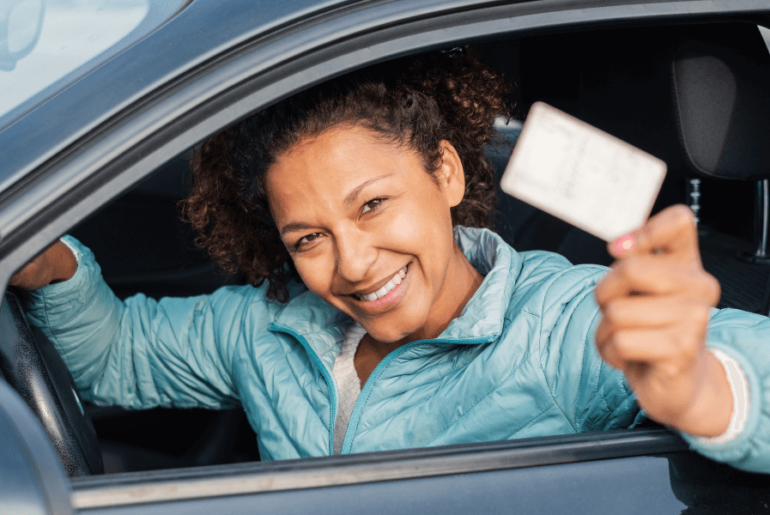 Licenses for immigrants without documents - hispanic woman holding driver's license