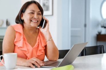 Hispanic woman on phone - Free internet and phone plans