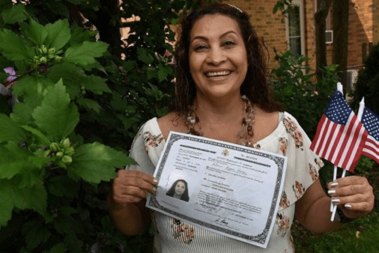 Woman holding naturalization certificate -Study resources for citizenship exam