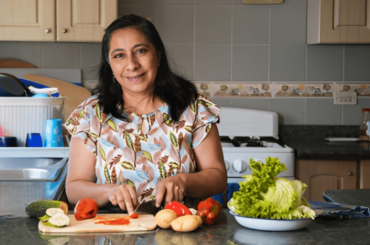 Hispanic woman cooking homemade food